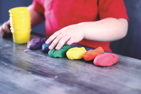 Preschool student playing with play dough